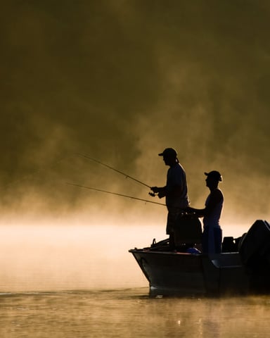 Two people fishing on a boat